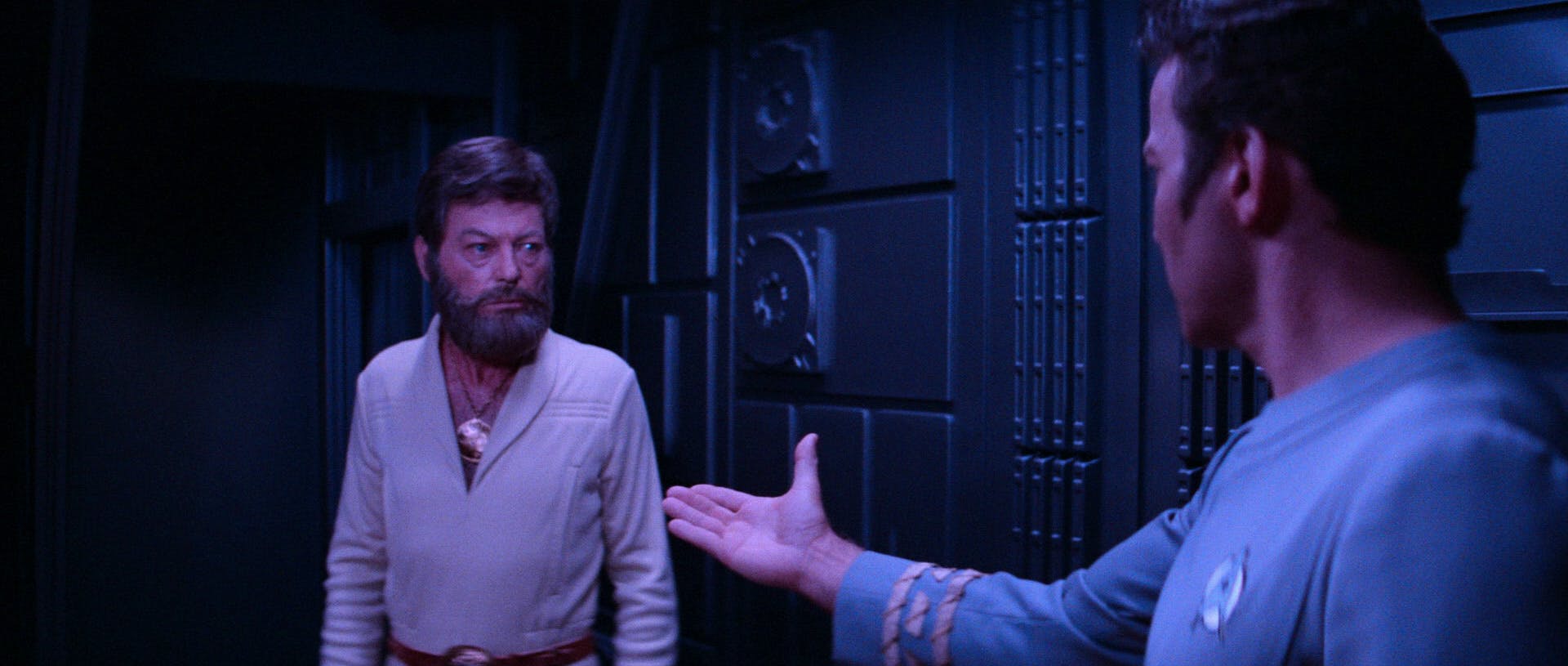 In a reunion, Kirk sticks his hand out to welcome his old friend, a weary and bearded McCoy, in Star Trek: The Motion Picture