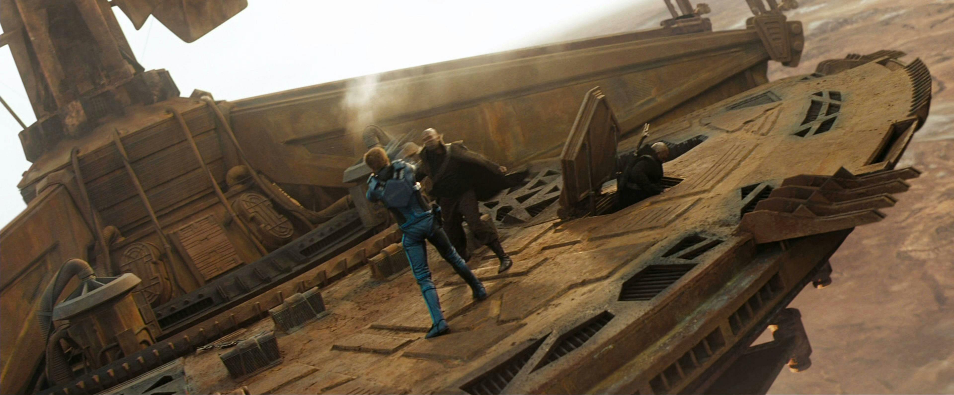 Kirk battles a Romulan from Nero's crew on top of a mining vessel on Vulcan in Star Trek (2009)