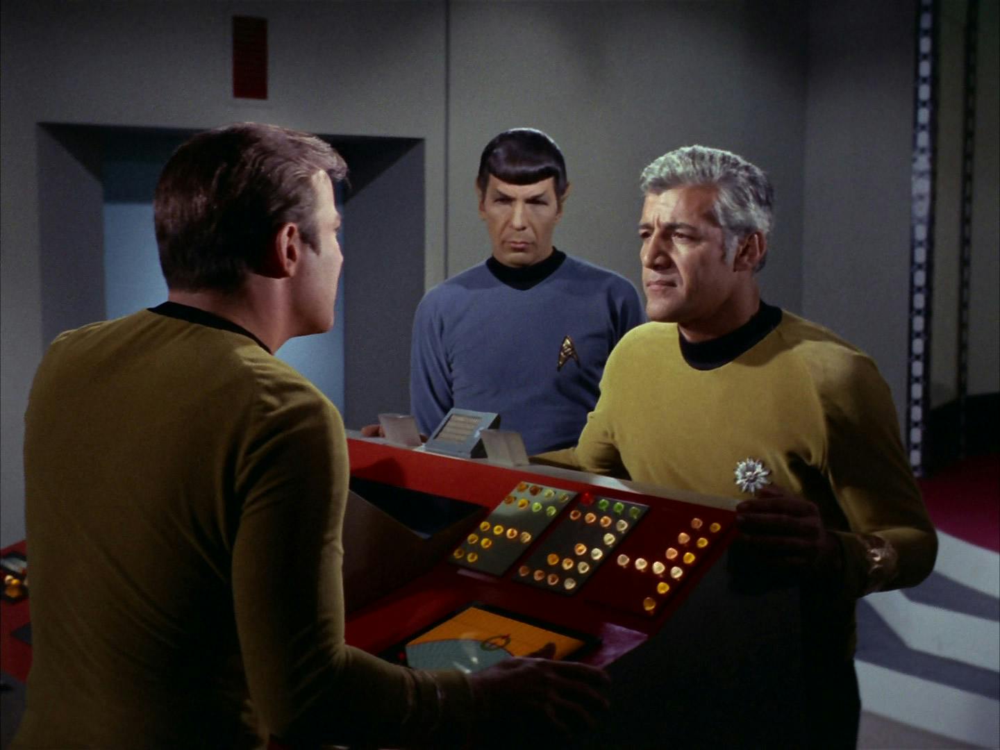 The Enterprise's Kirk and Spock welcome the commodore from Starbase 6 in 'The Ultimate Computer'