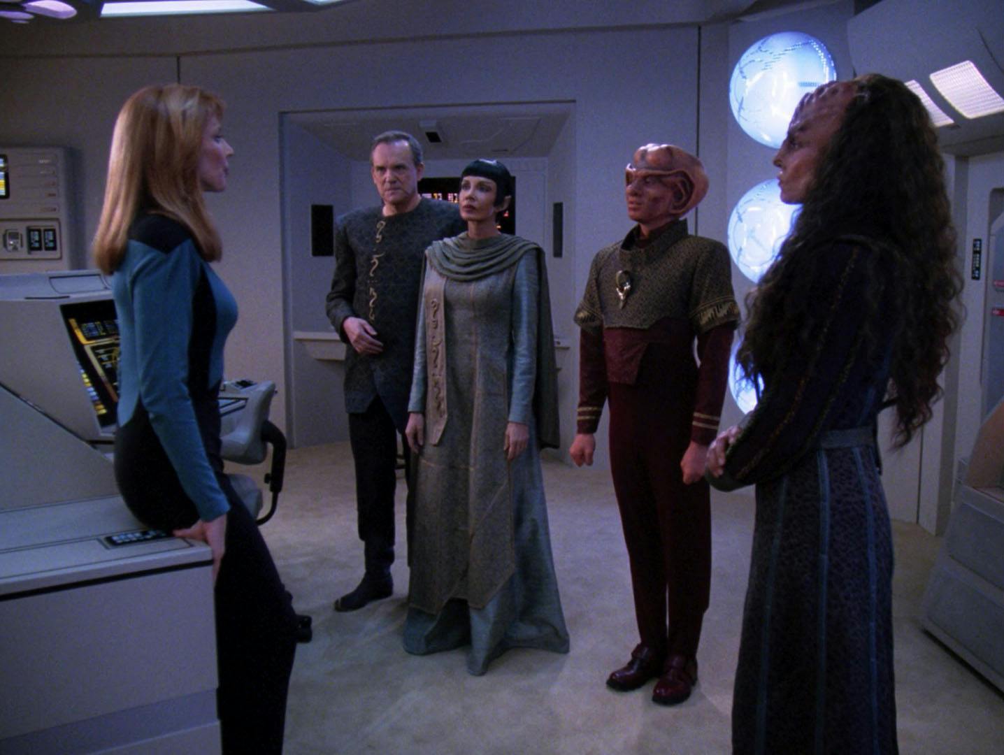 Dr. Crusher faces a tribunal of other respected medical scientists as they face her in the medbay in 'Suspicions'