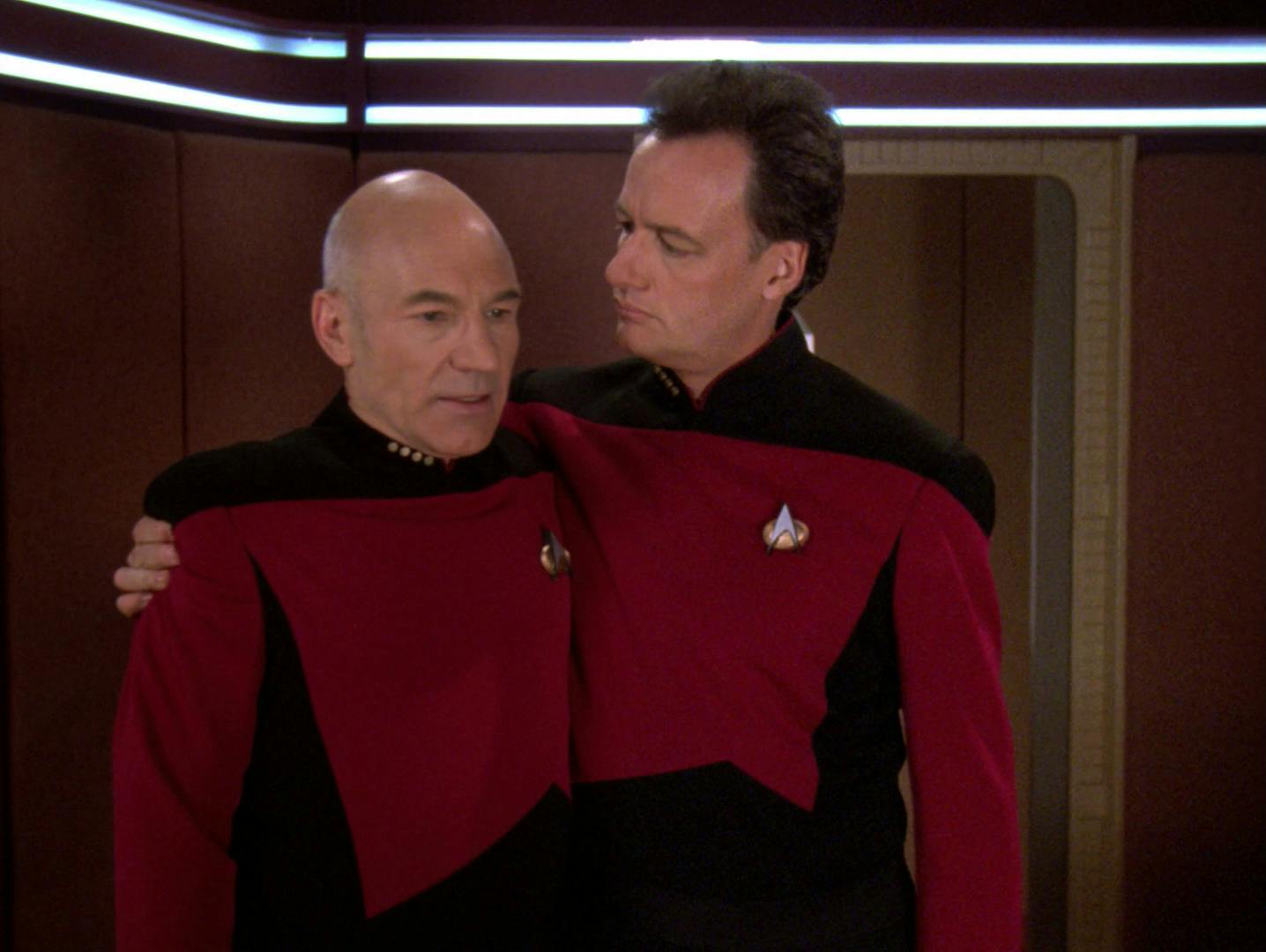 Q in a Starfleet uniform side hugs an uncomfortable Picard in his Ready Room in 'True Q'