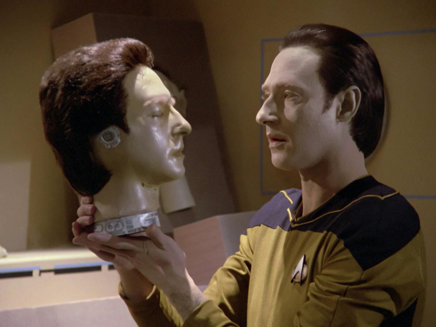 Data discovers parts of another android, his brother Lore, as he lifts his head in 'Datalore'