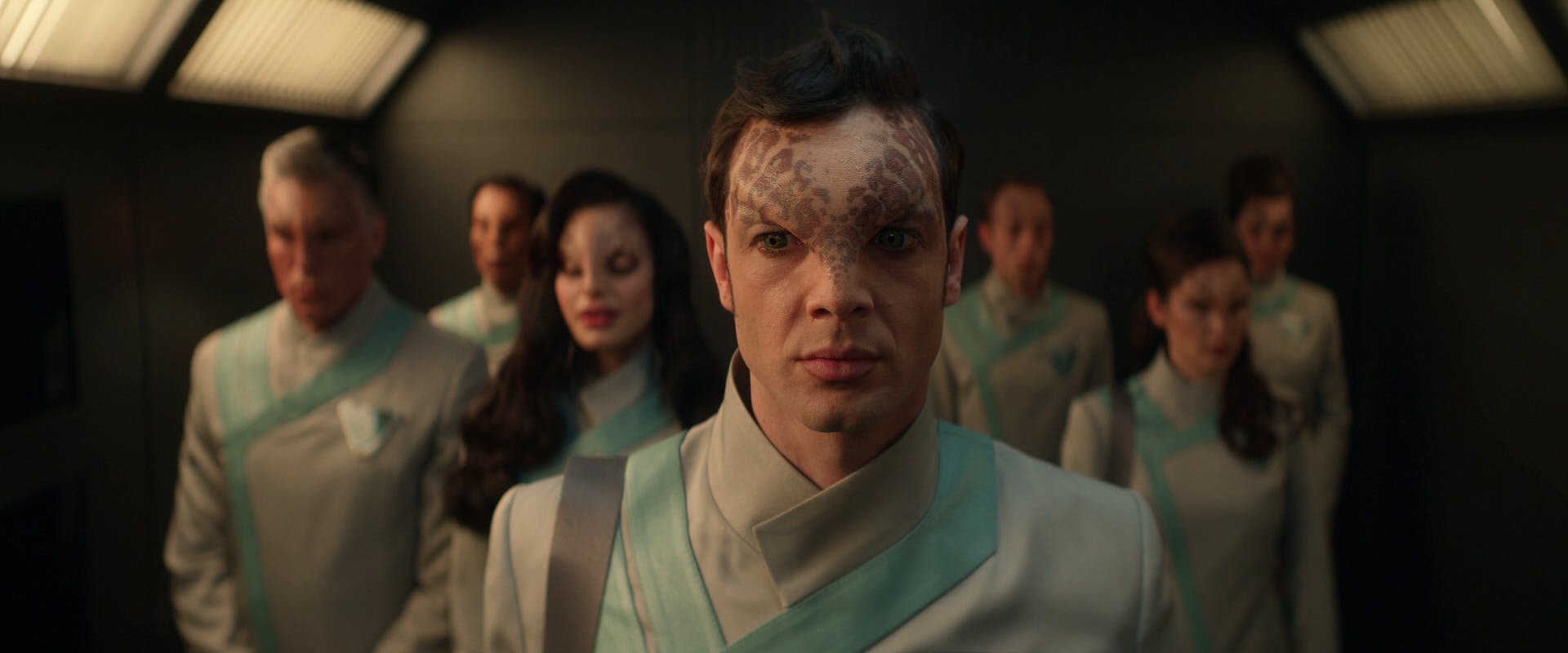 Spock, Pike, and La'An adopted short-term physiological changes to blend in with Kiley natives standing in a lift in 'Strange New Worlds'