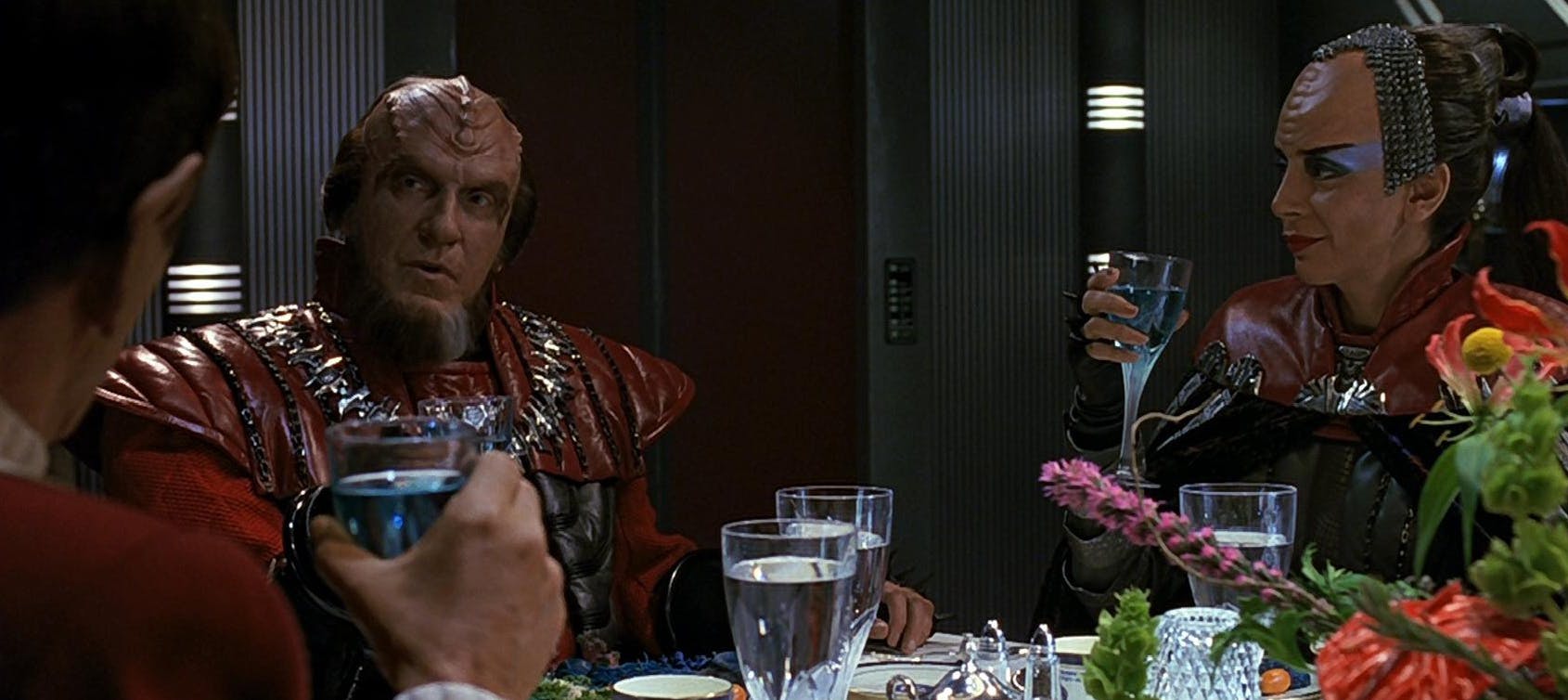 Gorkon converses with Spock at a feast bringing together both crews in Star Trek VI: The Undiscovered Country