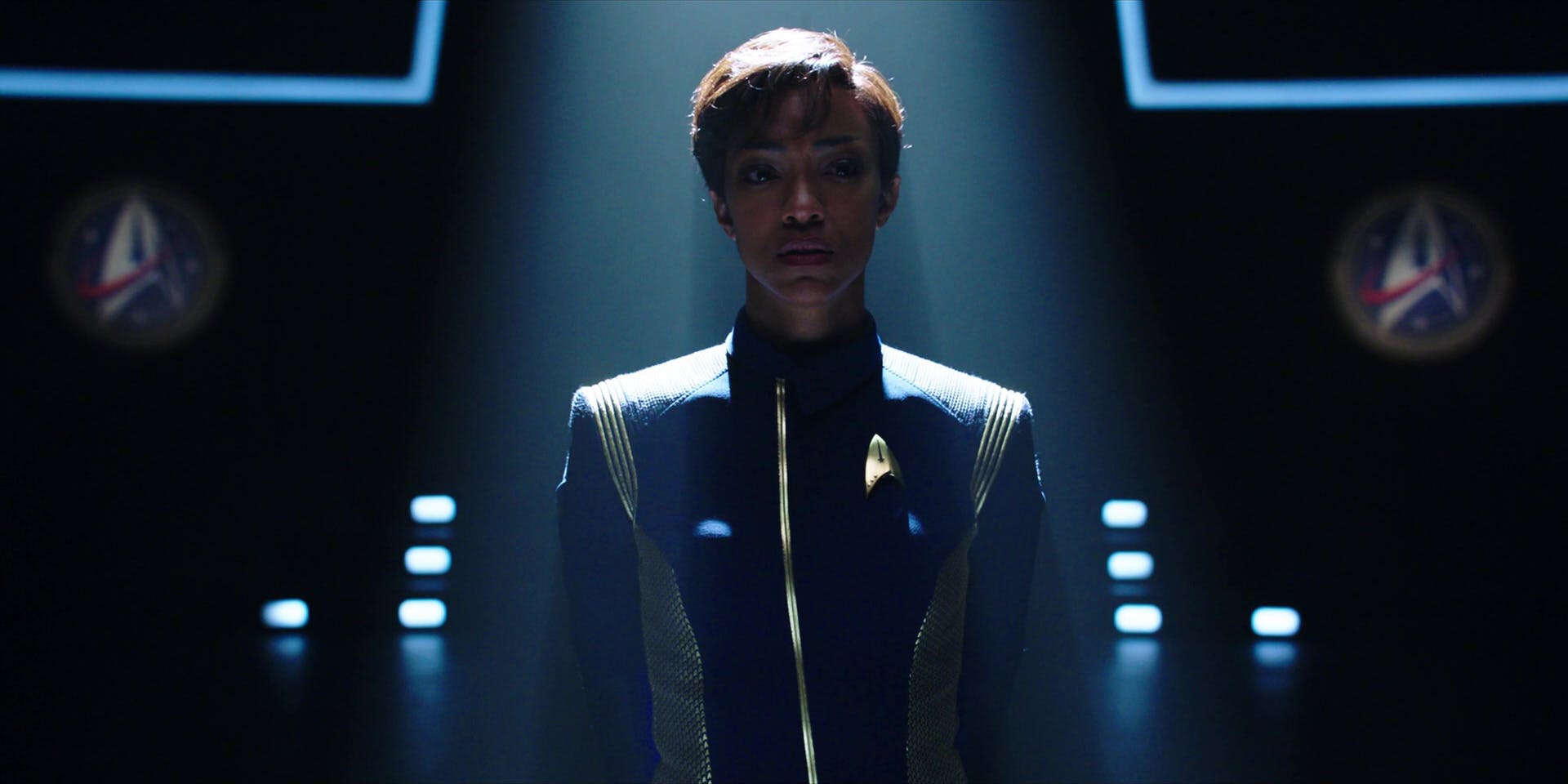 On Earth, Burnham stands before a Starfleet board for her court martial hearing in 'Battle at the Binary Stars'