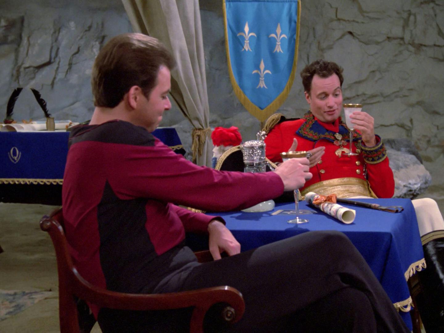 Q offers Riker a beverage and seat before offering a proposal in 'Hide and Q'