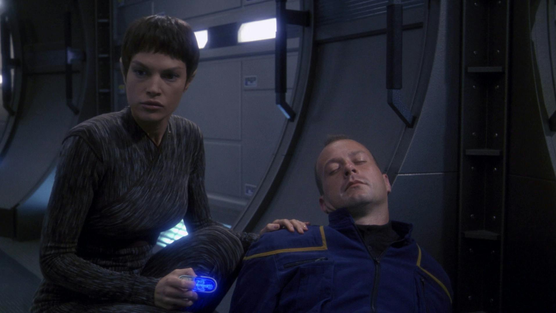 T'Pol checks on an unconscious crew member of the NX-01 as she safeguards the ship in 'Singularity'