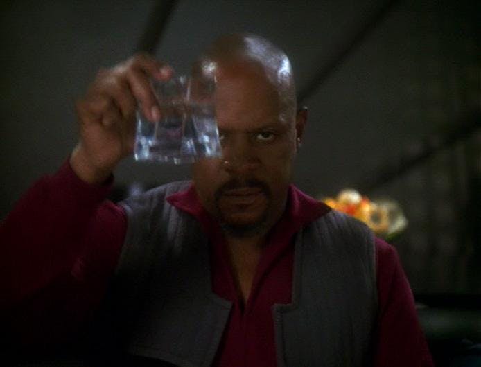 While recording his captain's log, Sisko reflects on the actions he took to turn the tide on the Dominion War. He raises his glass as he looks at his reflection on the window in 'In the Pale Moonlight'