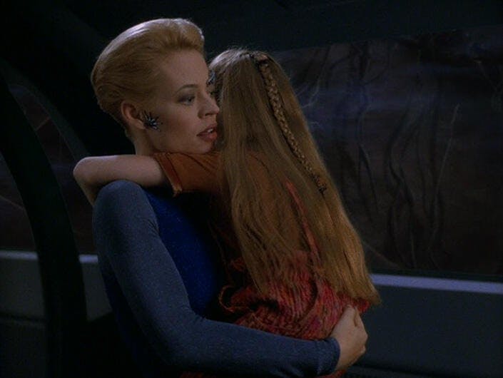 Seven of Nine carries Naomi Wildman in her arms in 'Bliss'