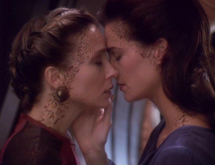 Lenara Kahn and Jadzia Dax close their eyes and lean in for an intimate embrace in 'Rejoined'