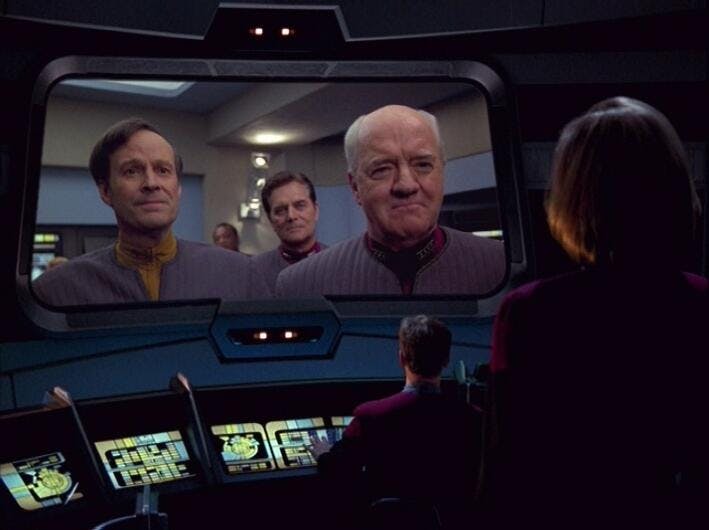 Barclay and Admiral Owen Paris on the viewscreen looking at Tom Paris and Captain Janeway in 'Endgame'