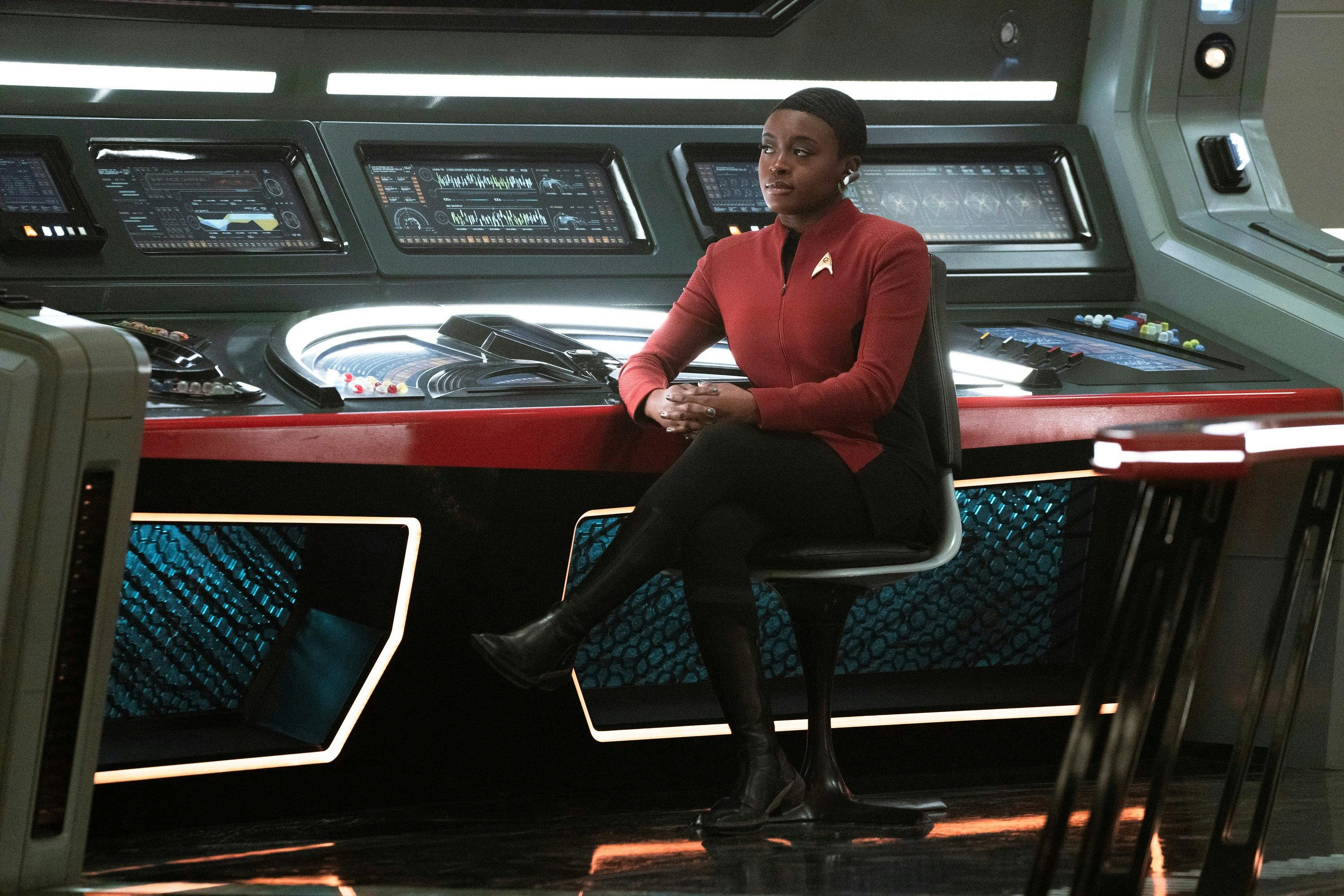 Uhura sits at her comm stations on the bridge of the Enterprise in 'Subspace Rhapsody'