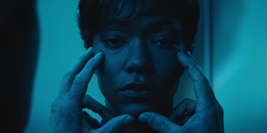 Close-up of Michael Burnham's face as Sarek performs a mind-meld in 'Battle of the Binary Stars'