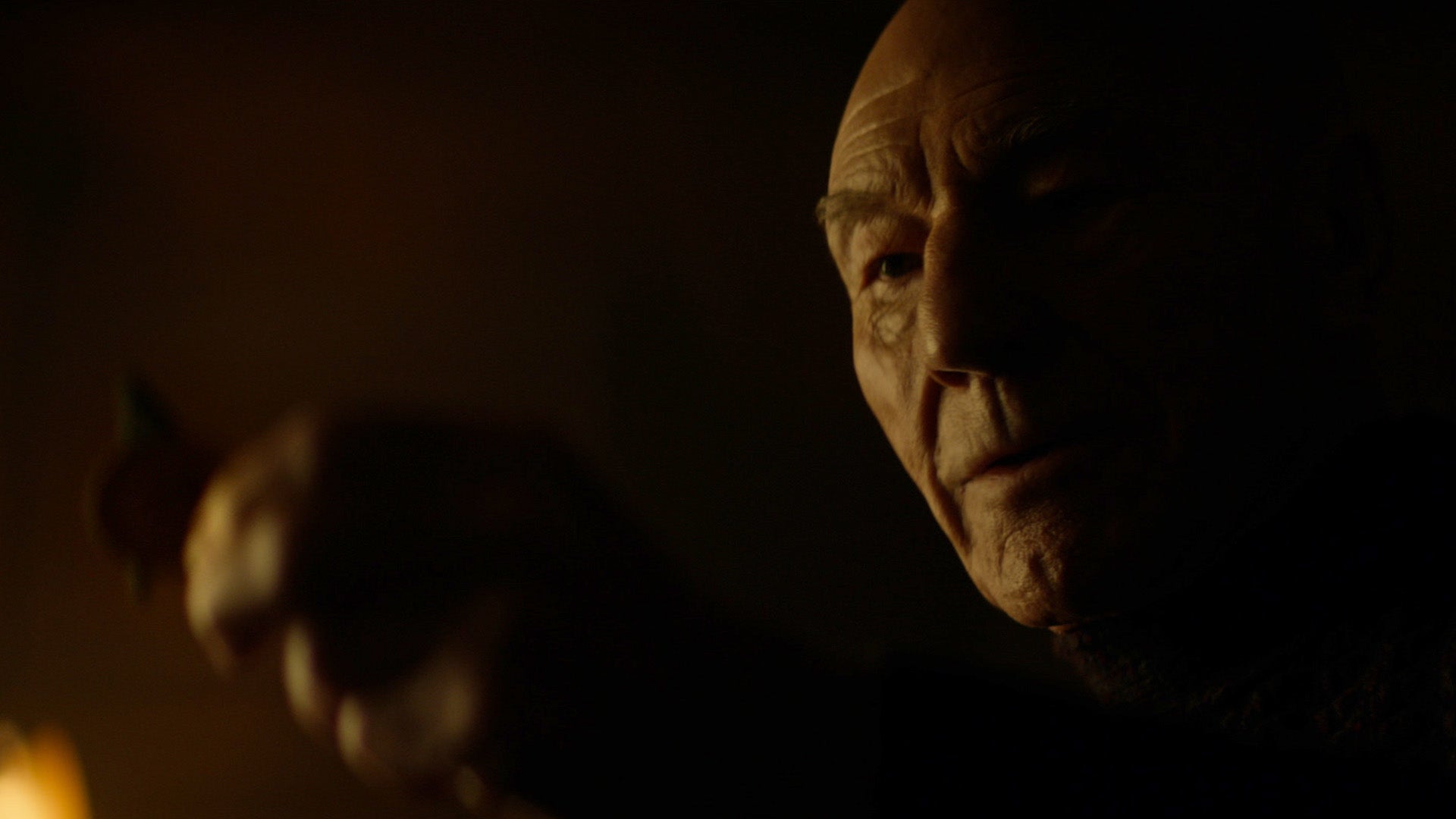 Jean-Luc Picard looks at his old Enterprise-D communicator 