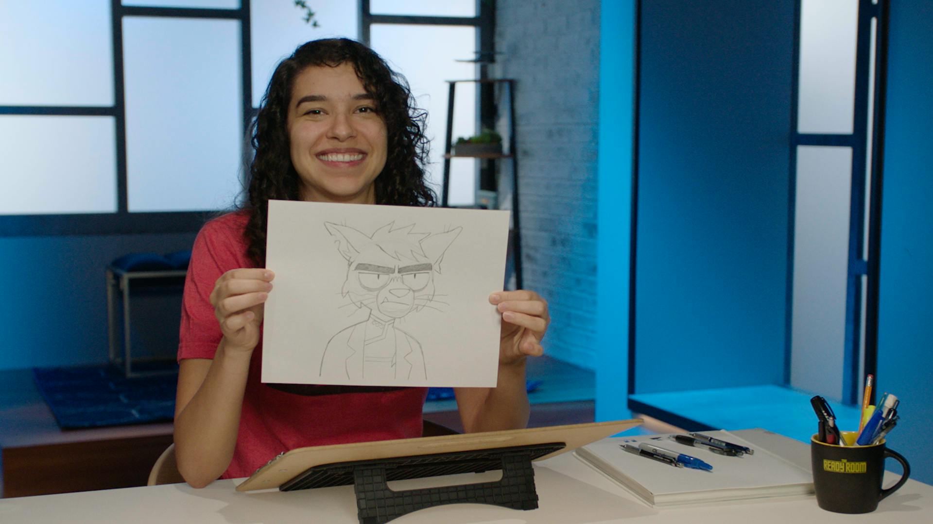 Marisa Livingston holds up a drawing of Dr. T'Ana after she teaches you how to draw