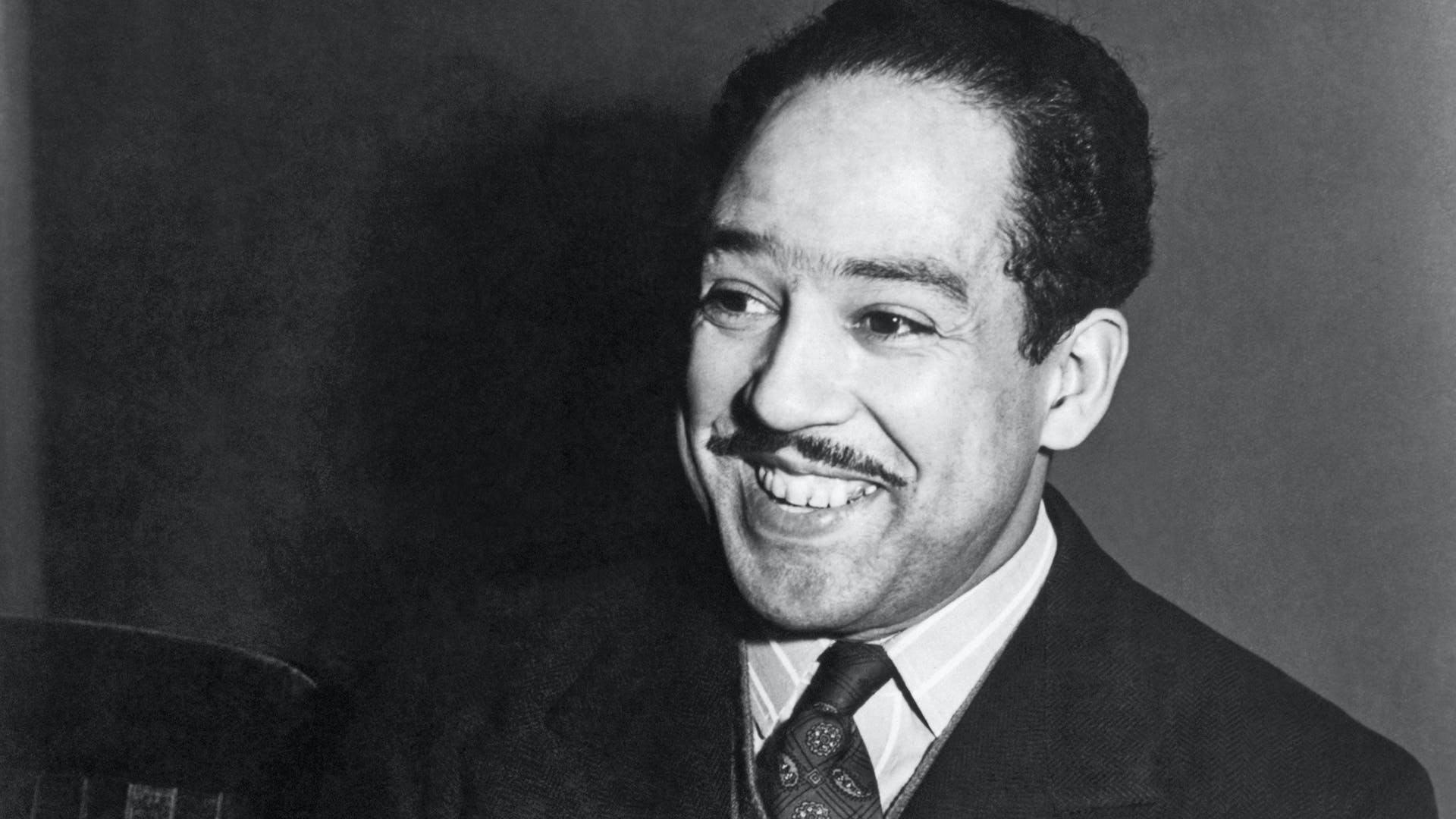 A portrait of a smiling Langston Hughes