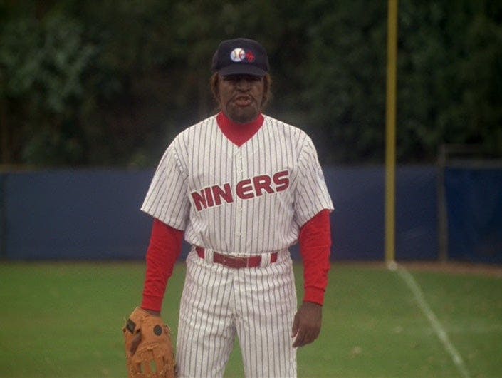 Worf in his baseball uniform in the middle of a game in a Holosuite simulation on Star Trek: Deep Space Nine