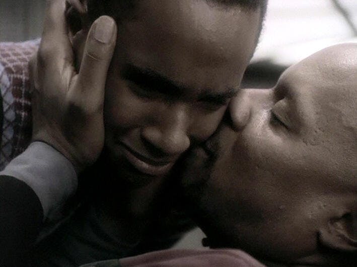 Ben Sisko kisses his son Jake's cheek in an emotional moment