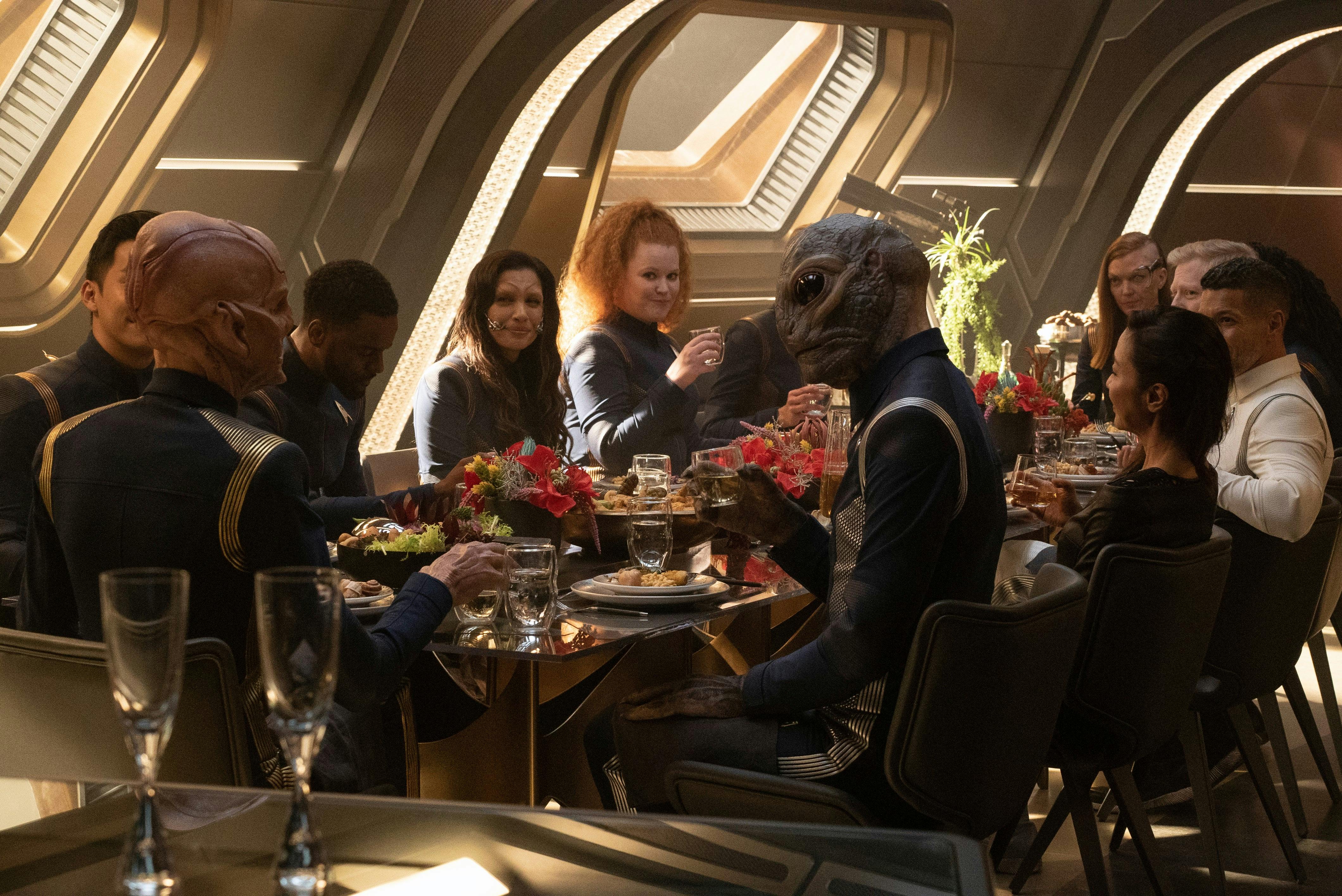 The crew sit down for a meal in in 'Forget Me Not'