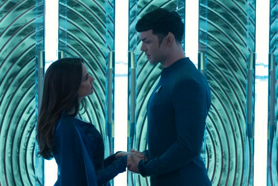 Amanda Grayson and Spock stand on the transporter pad holding hands and each other&#x27;s gaze in &#x27;Charades&#x27;
