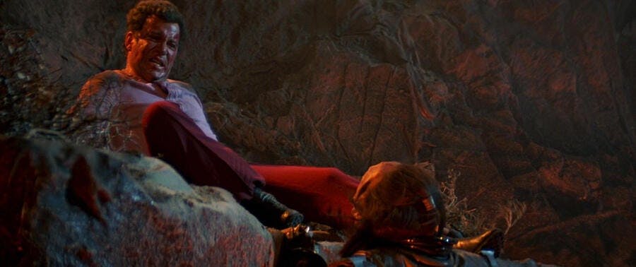 A beaten Kirk kicks Kruge who clings to the side of the cliff in 'The Search for Spock'
