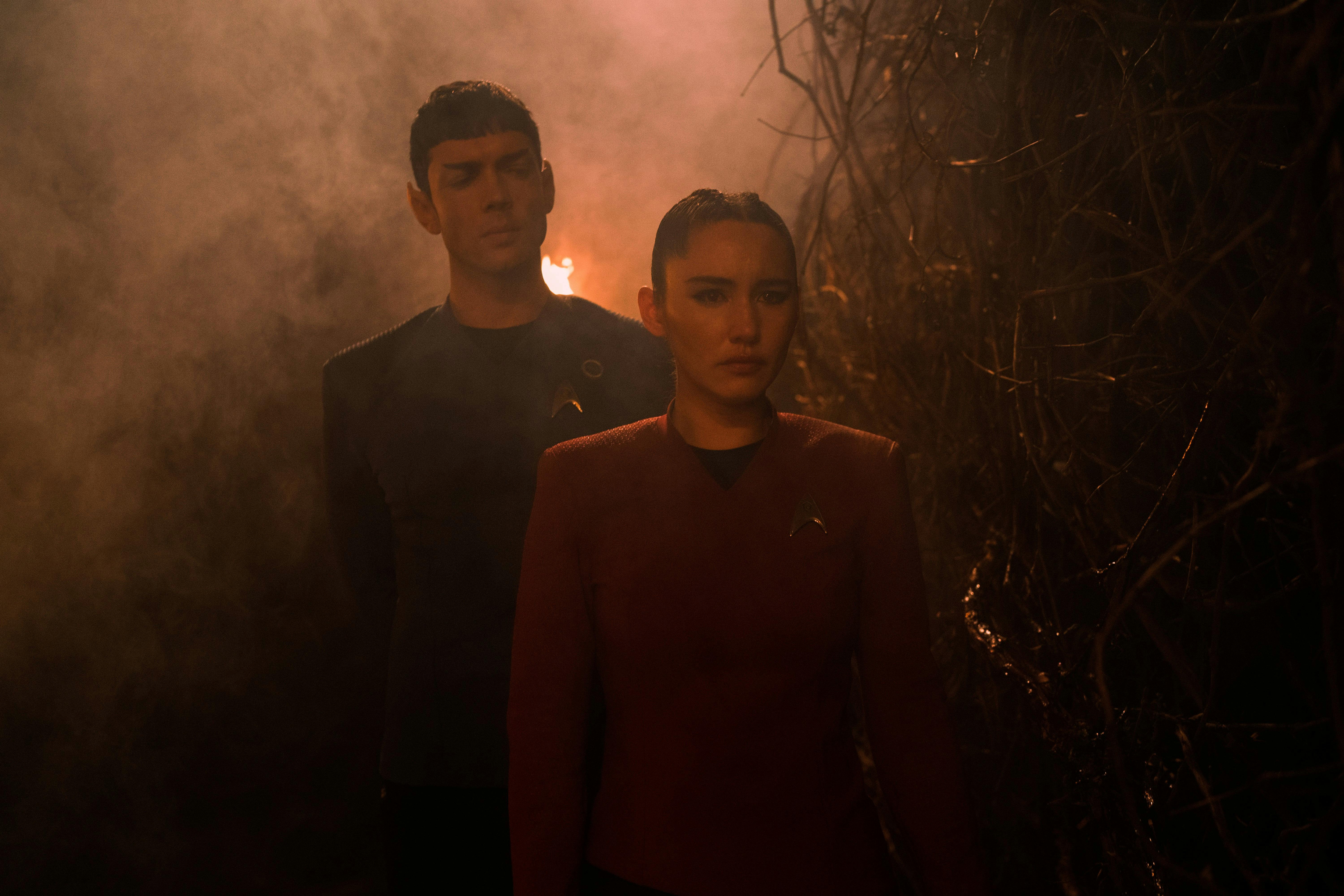 Spock (Strange New Worlds) and La'an Noonien Singh stand next to each other, looking concerned.