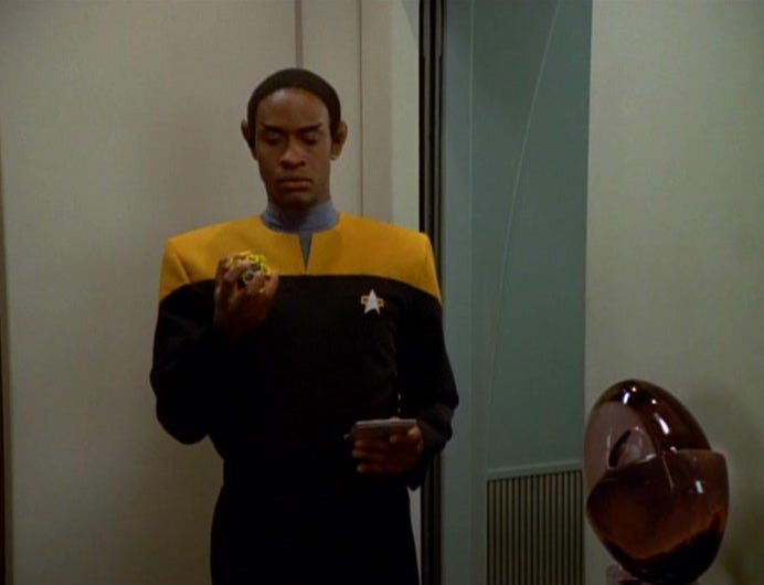 Tuvok holds a tennis ball in his hand
