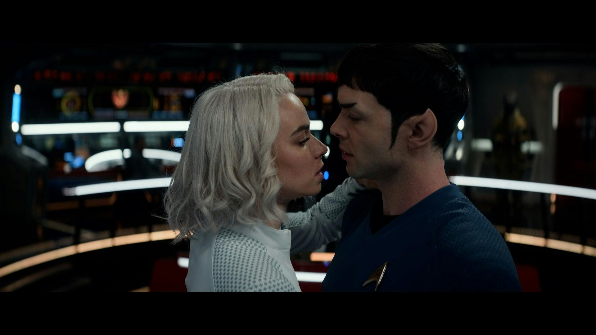 Nurse Chapel (Jess Bush) and Spock (Ethan Peck) kiss on the bridge of the Enterprise.