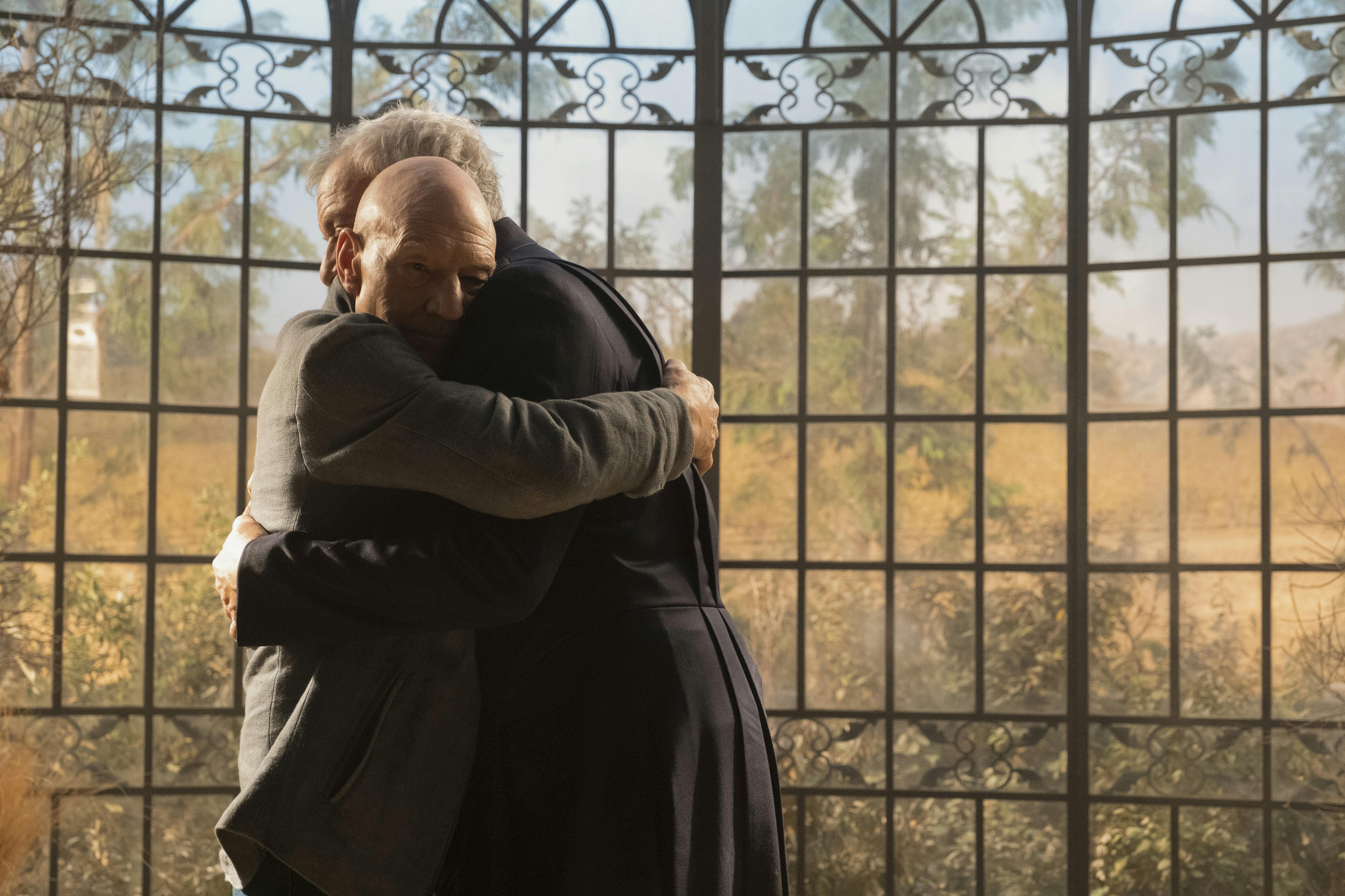 Jean-Luc Picard and Q engage in a warm embrace in 'Farewell'