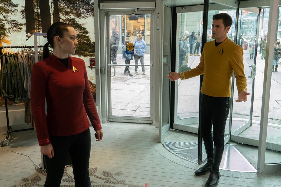 James Kirk and La'An stand in a department store in front of turnstile door in 'Tomorrow and Tomorrow and Tomorrow'