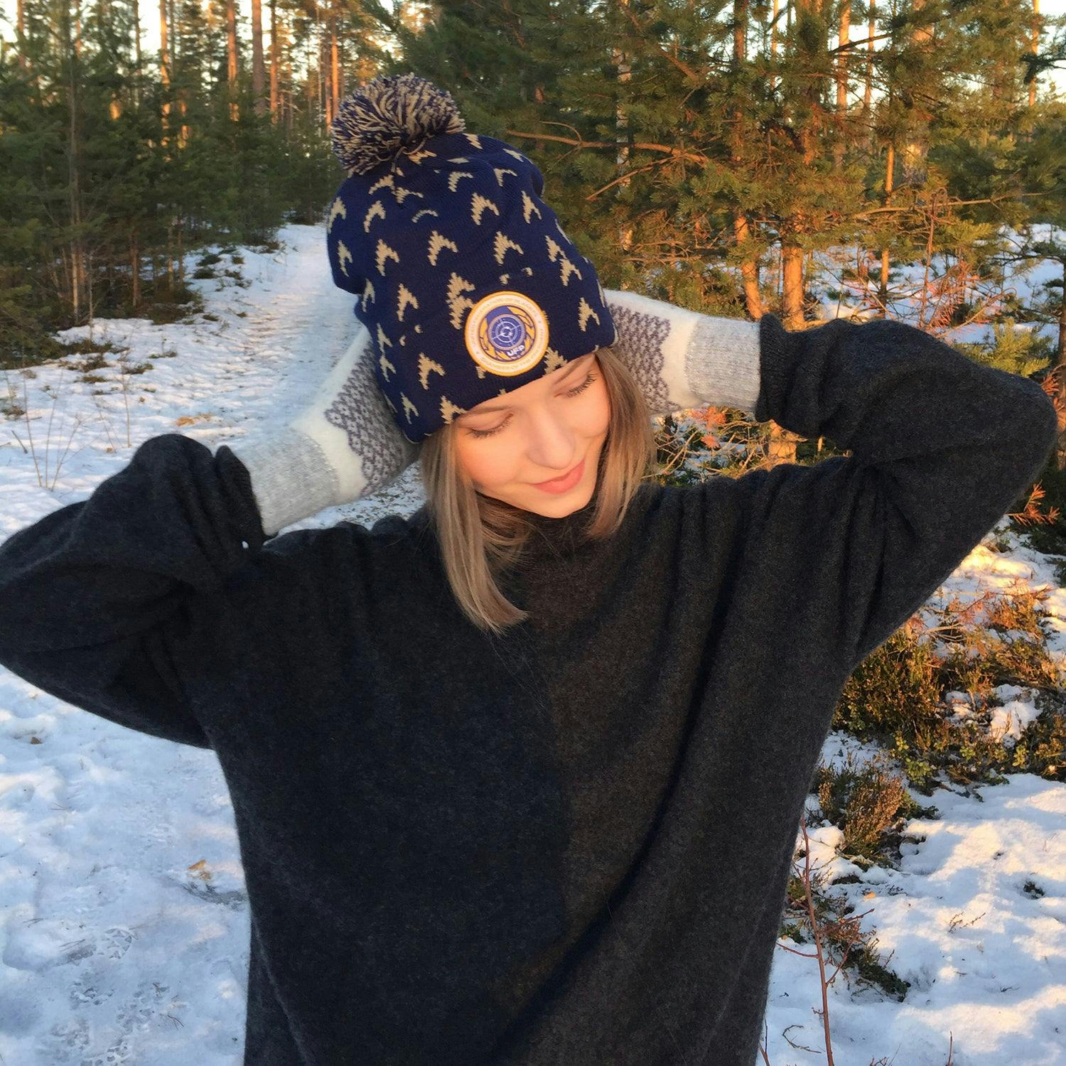 Female model wearing Lovarzi's Star Trek: Discovery United Federation of Planets beanie out in the snow