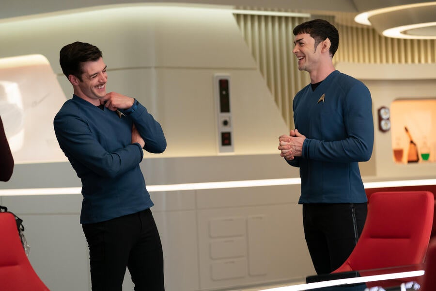 Dan Jeannotte and Ethan Peck talk between takes.