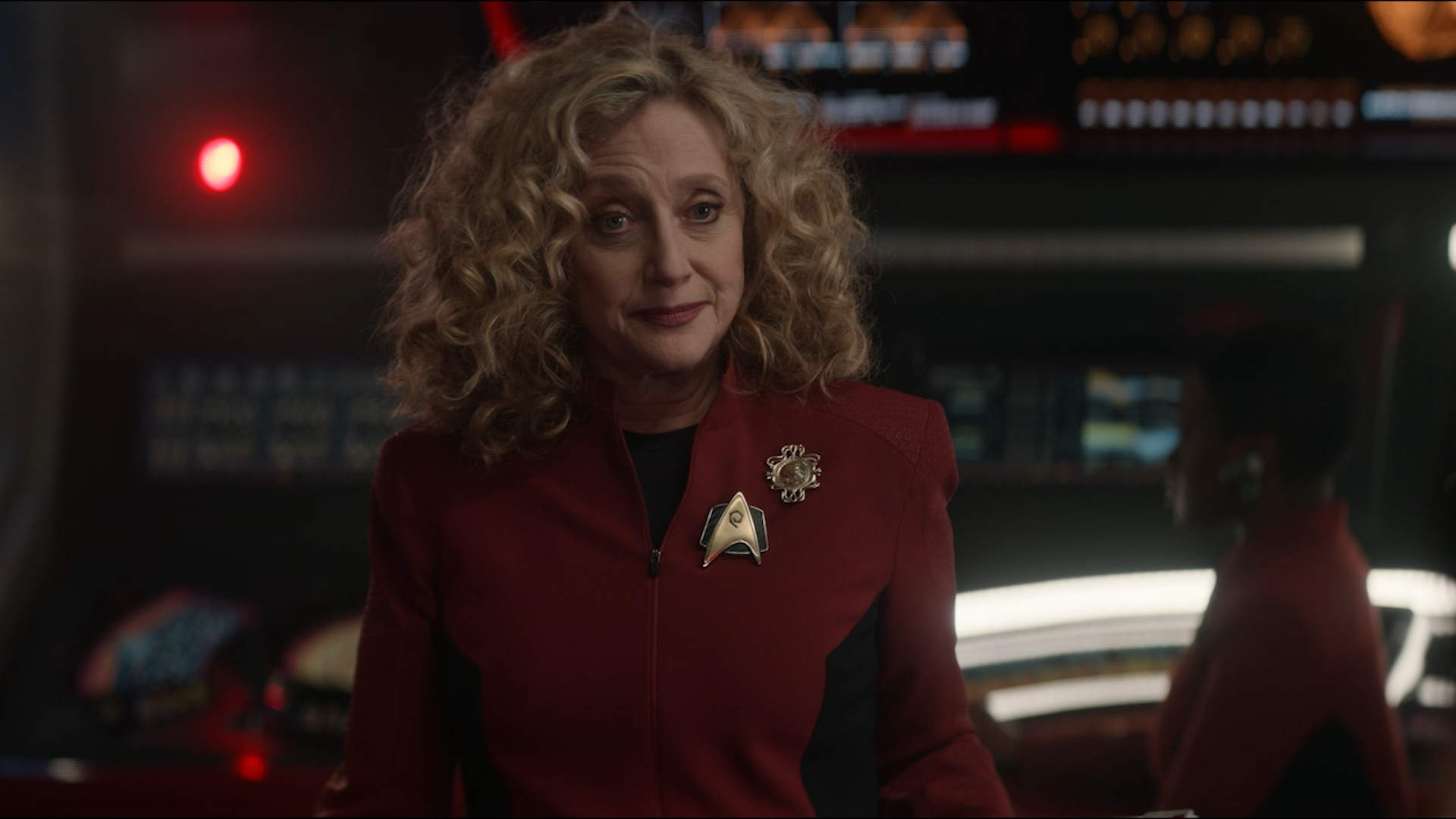 Commander Pelia stands on the bridge of the Enterprise facing the captain's chair in 'The Broken Circle'