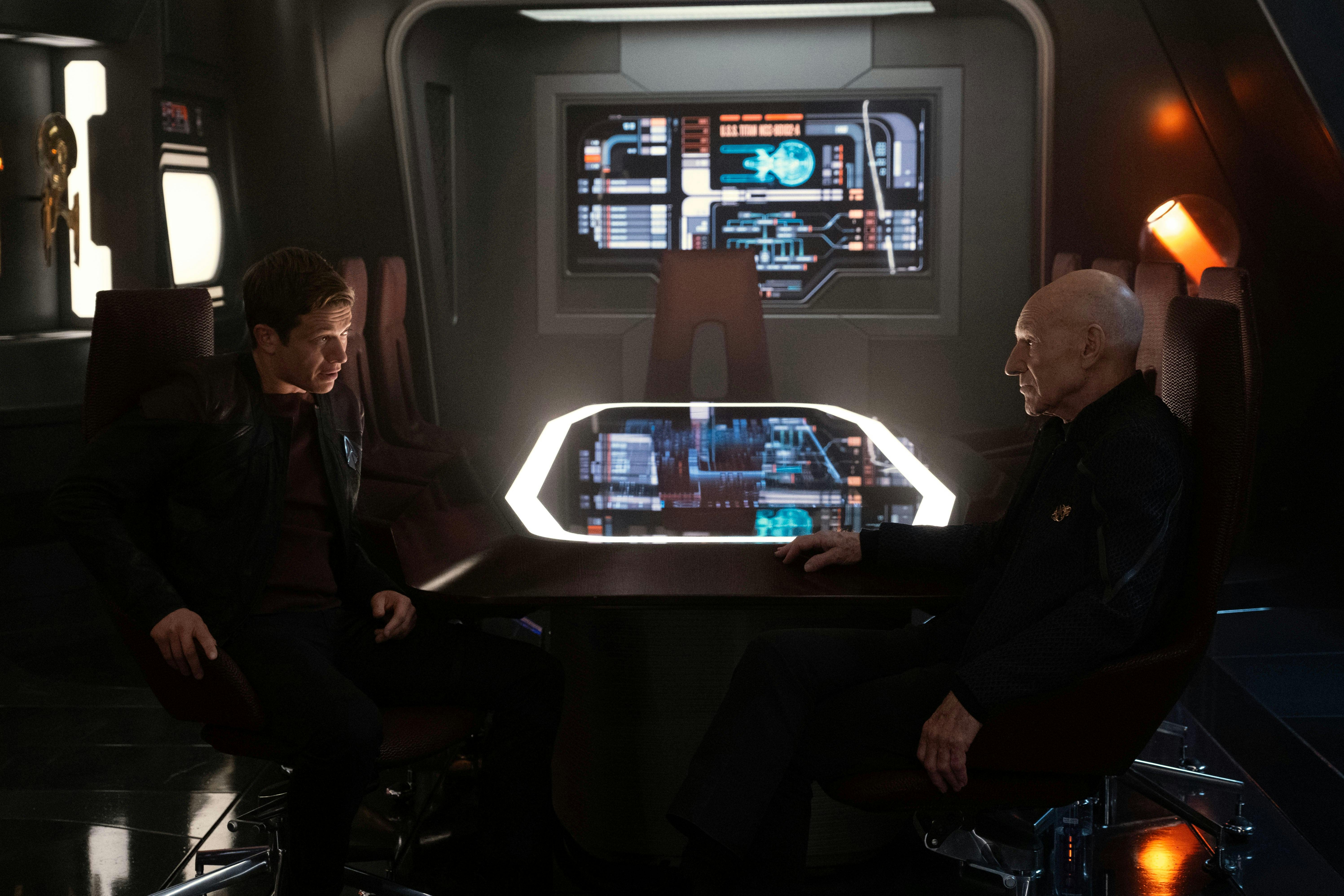 Jack Crusher sits facing his father Jean-Luc Picard in the Observation Lounge