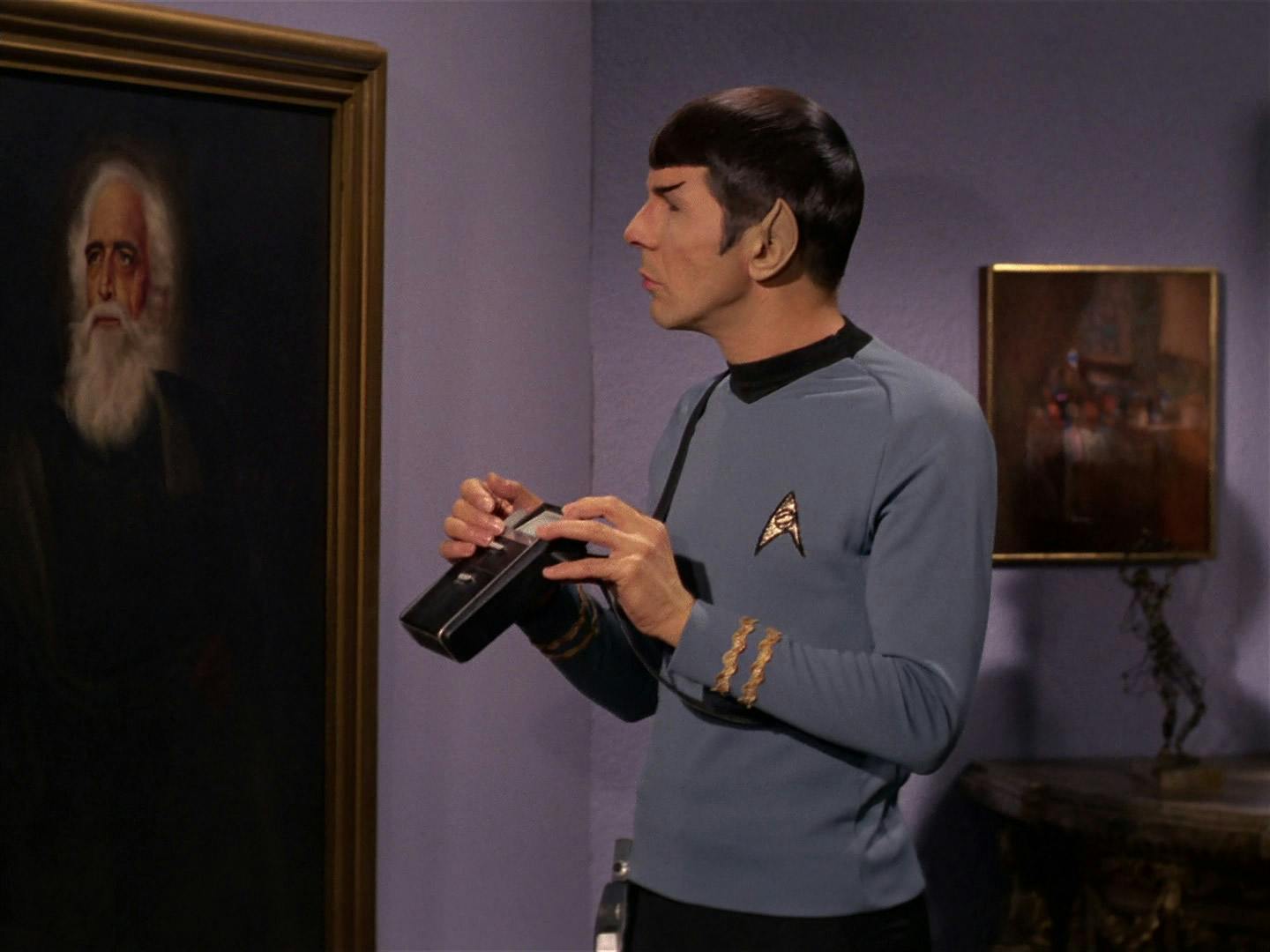 Spock lifts his tricorder while observing a painting in Flint's Gallery in 'Requiem for Methuselah'