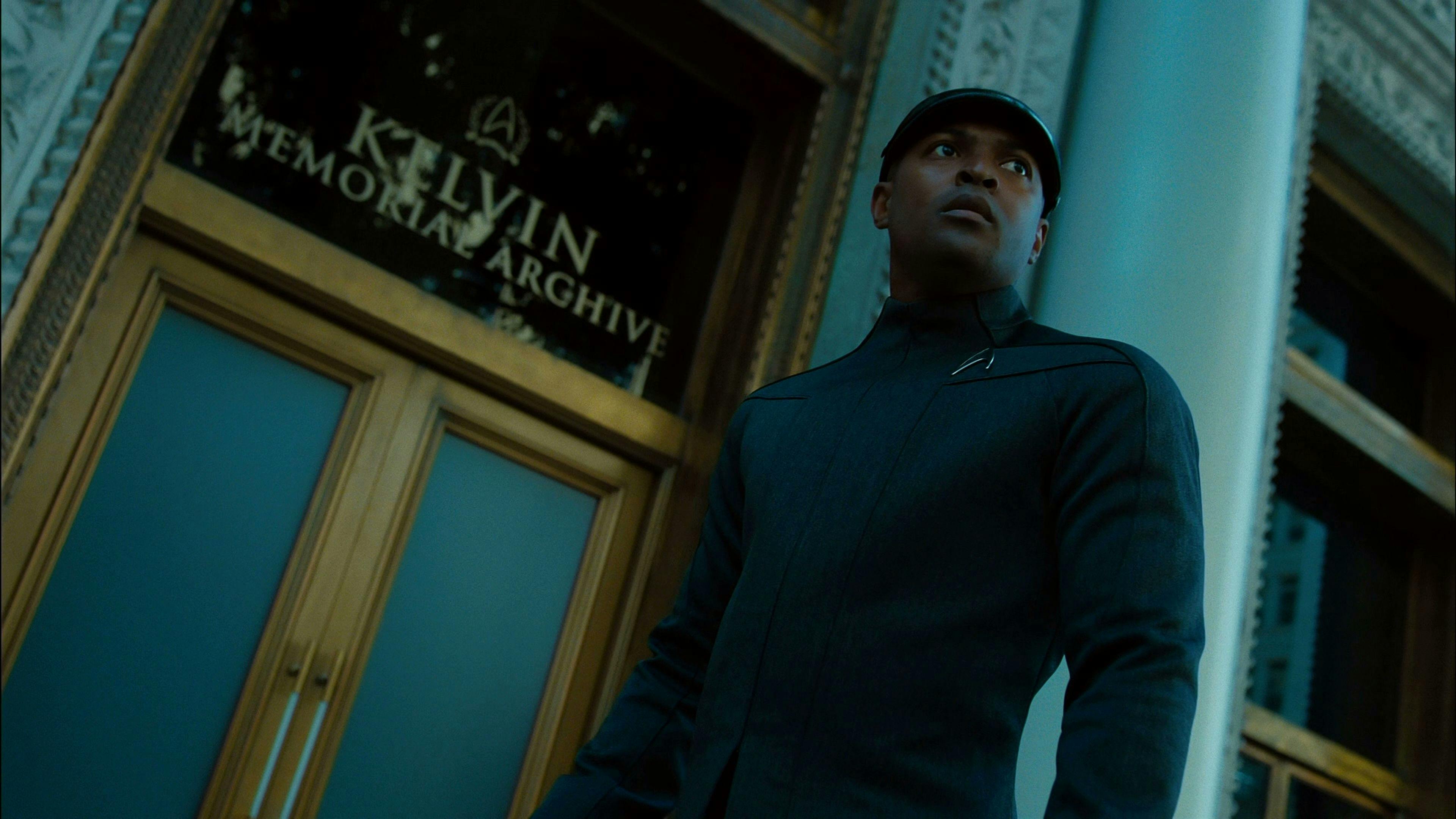 Thomas Harewood pauses in front of the Kelvin Memorial Archive as he looks over his shoulder in Star Trek Into Darkness