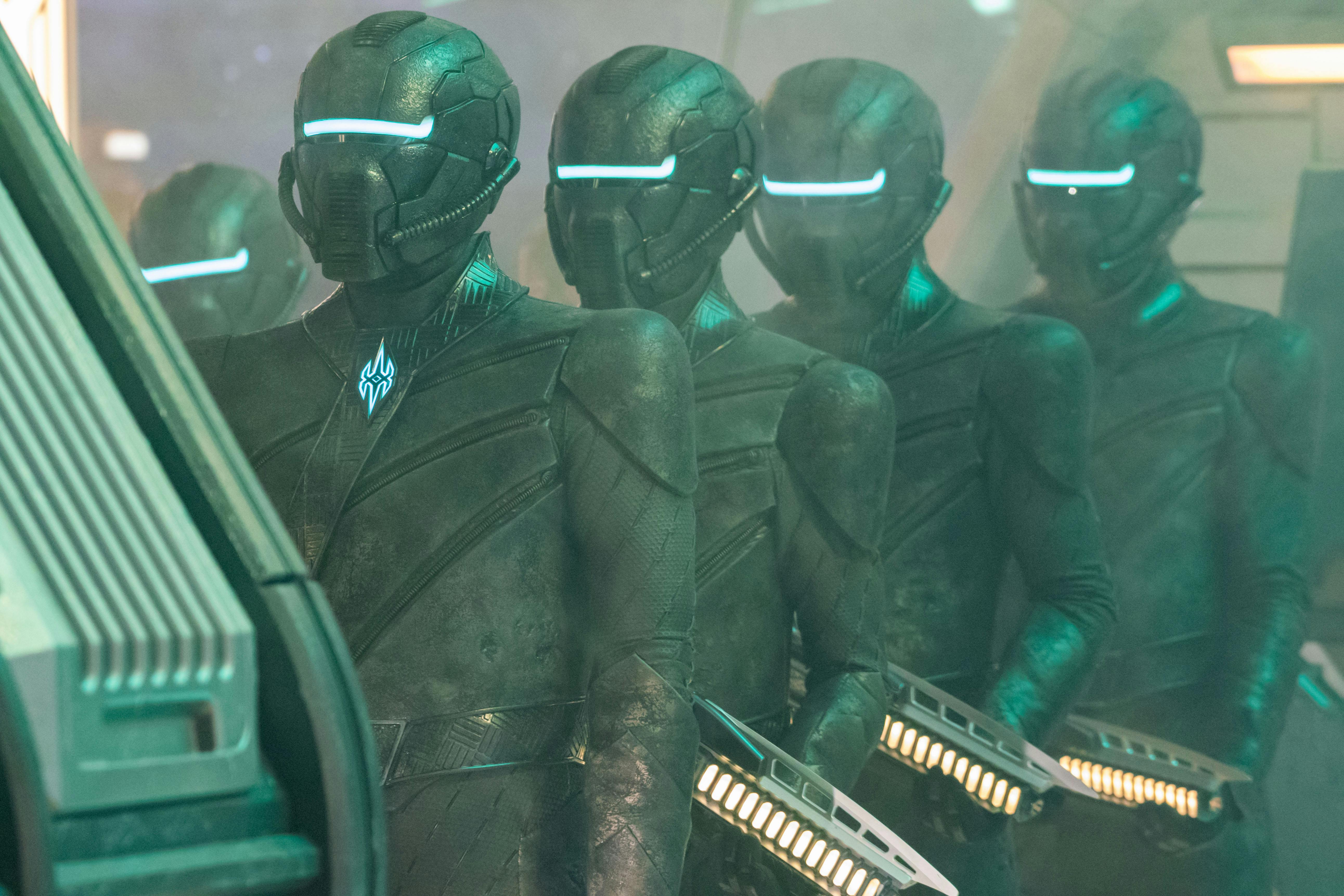 The science officers of the Breen line up with phaser blasters in hand in front of the Progenitor structure in 'Lagrange Point'