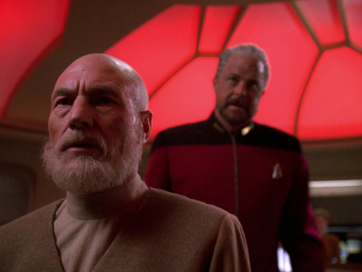 An alt-future Picard looks out the viewscreen with an alt-future Riker standing behind him on the bridge in 'All Good Things...'