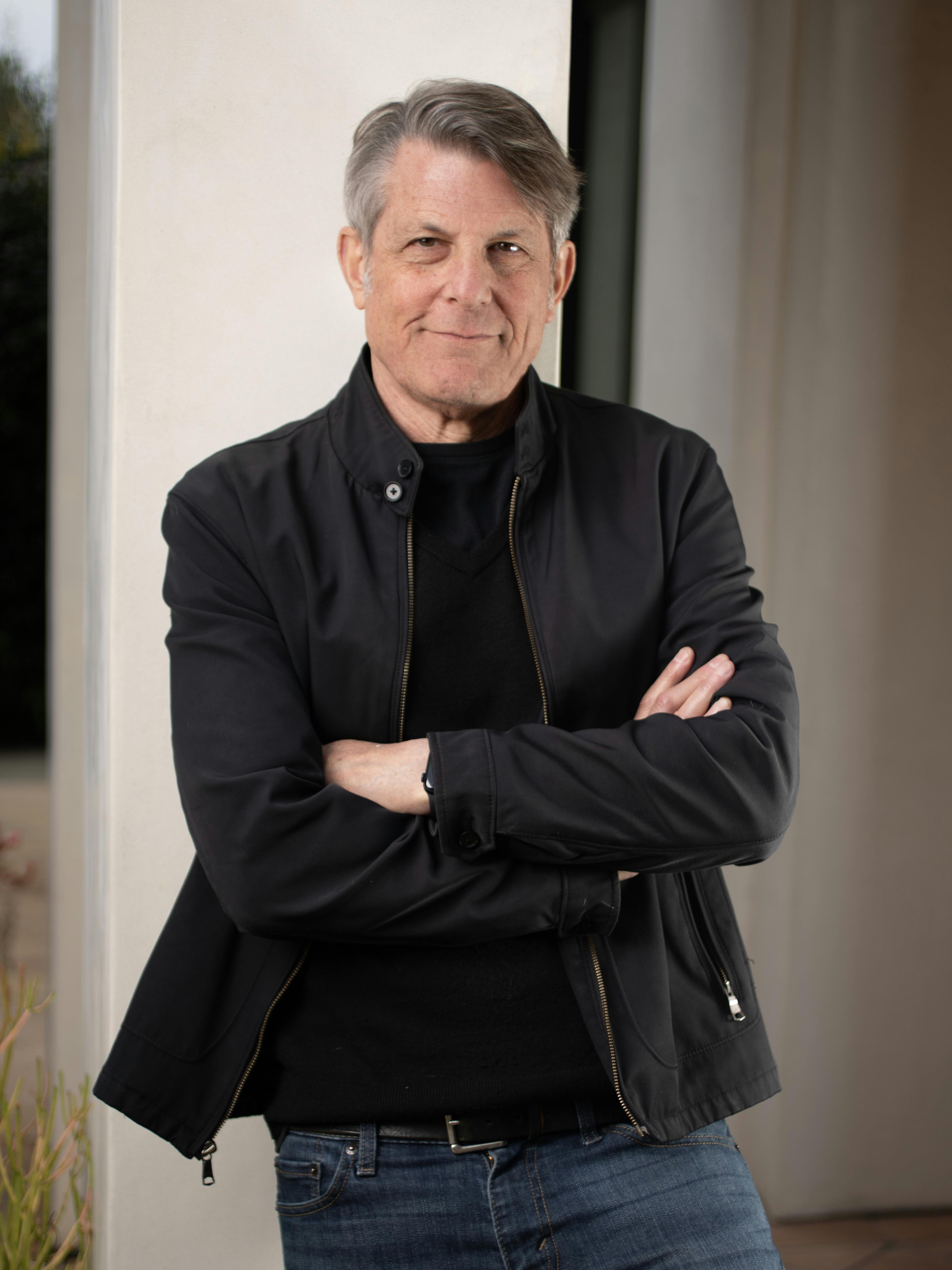 Portrait of Adam Nimoy with his arms crossed in front of him