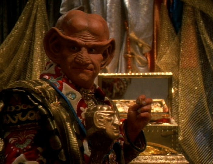 Neelix dons a disguise as a Ferengi in full regalia in a ruse to out two fraudsters in 'False Profits'