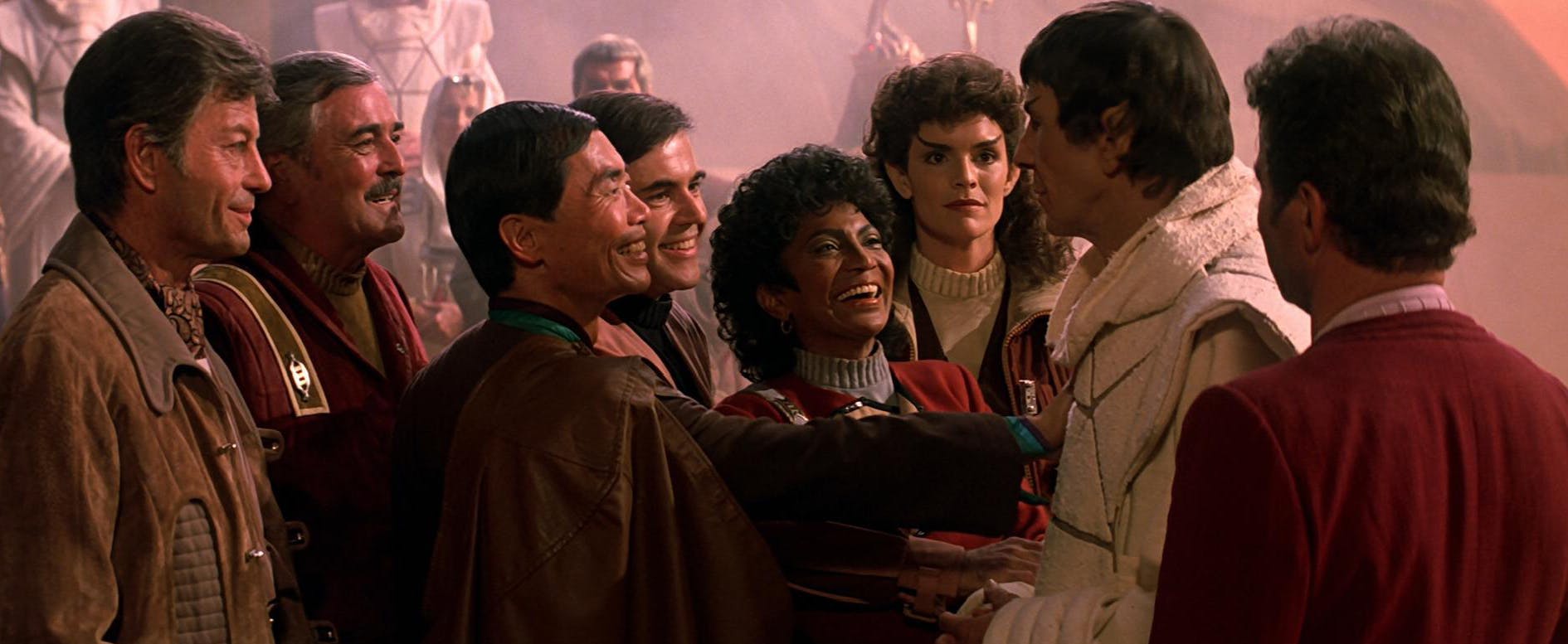 The Enterprise crew (Bones, Scotty, Sulu, Chekov, Uhura, Saavik, and Kirk) are joyful with the return of Spock in Star Trek III: The Search for Spock