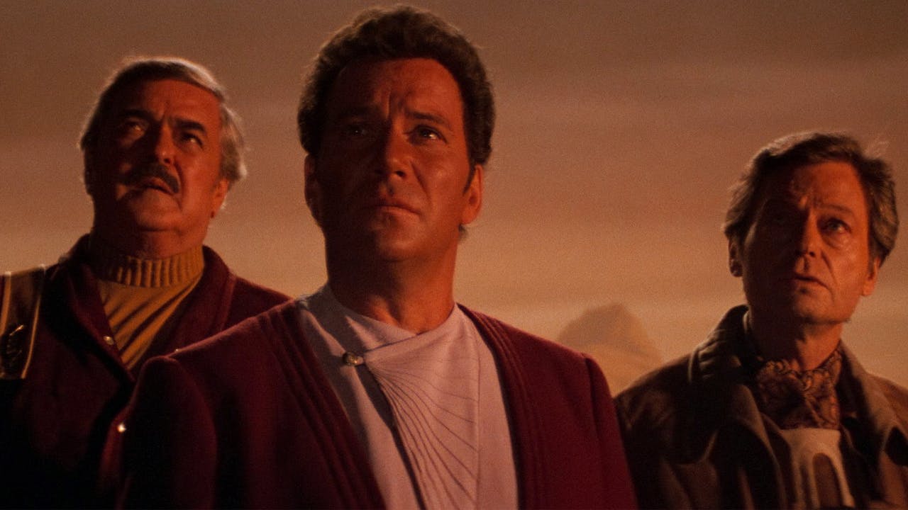Scotty, Kirk, and Bones look up towards the sky in Star Trek III: The Search for Spock