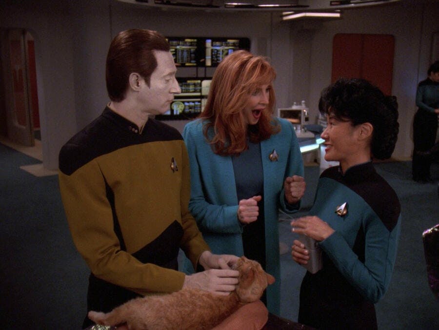 Data worries about his cat Spot while Dr. Beverly Crusher reacts in delight in response to Nurse Alyssa Ogawa in 'Genesis'
