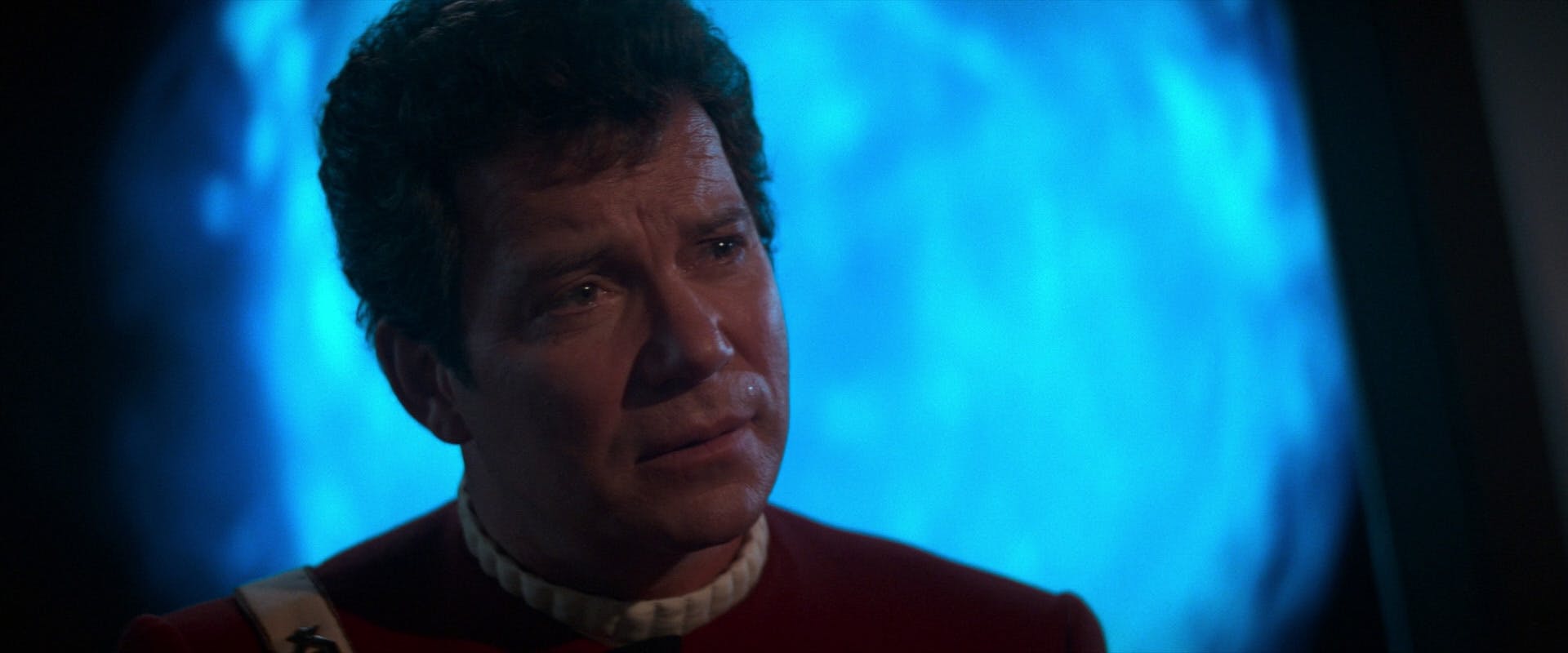 Close-up of a contemplative Captain Kirk in Star Trek V: The Final Frontier 