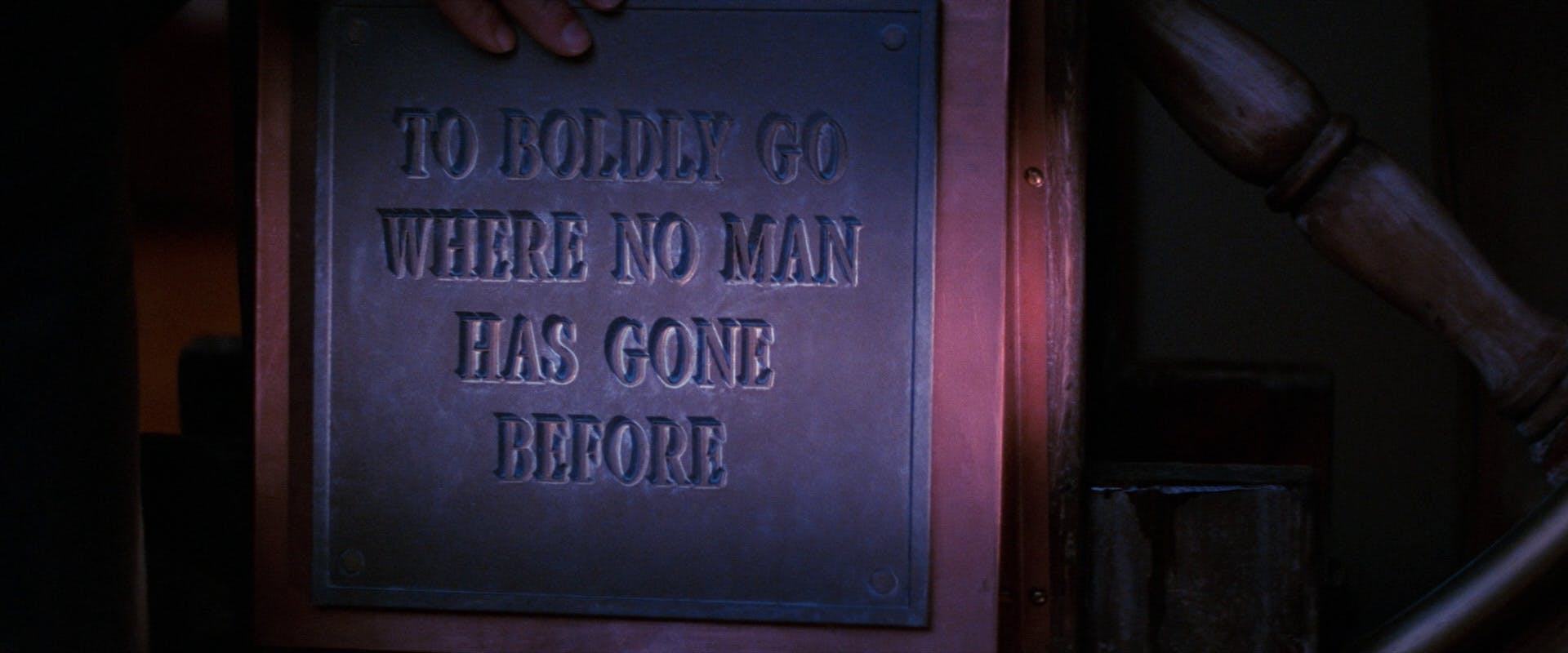 Close-up of the plaque with the words 'To boldly go where no man has gone before' in Star Trek V: The Final Frontier