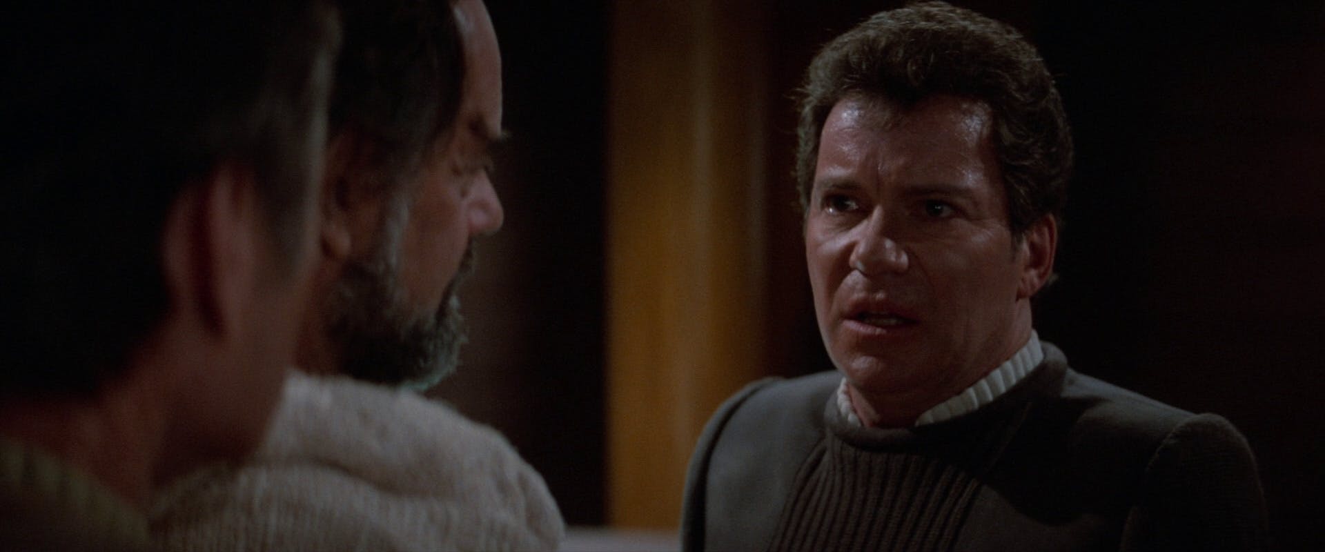 Kirk faces Sybok, as McCoy watches, telling him that he refuses to take away his pain in Star Trek V: The Final Frontier