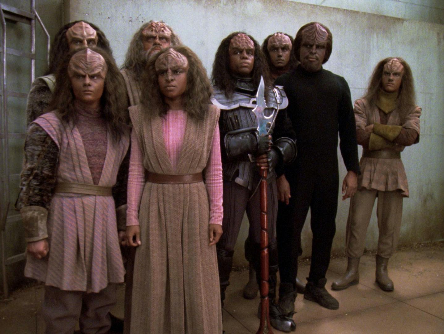 In a Romulan prison camp, several Klingons stand besides Worf after he teaches them about their culture in 'Birthright, Part II'