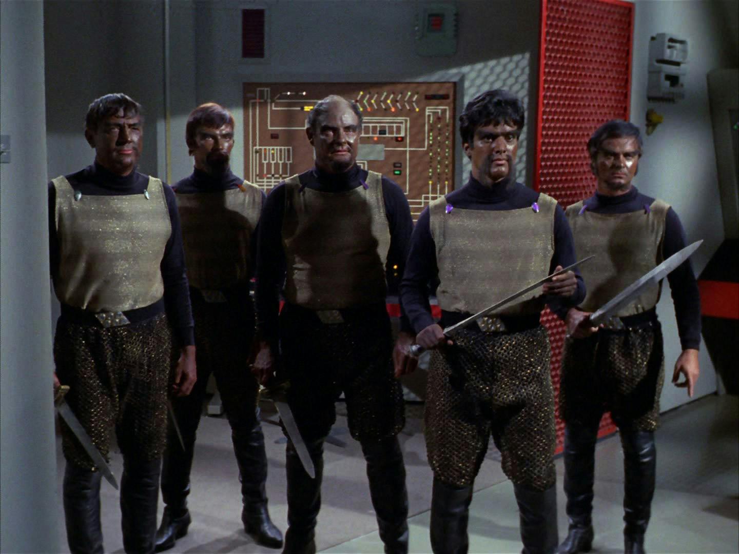 A group of Klingons aboard the U.S.S. Enterprise carry their swords in their hand in a defensive stand in 'Day of the Dove'