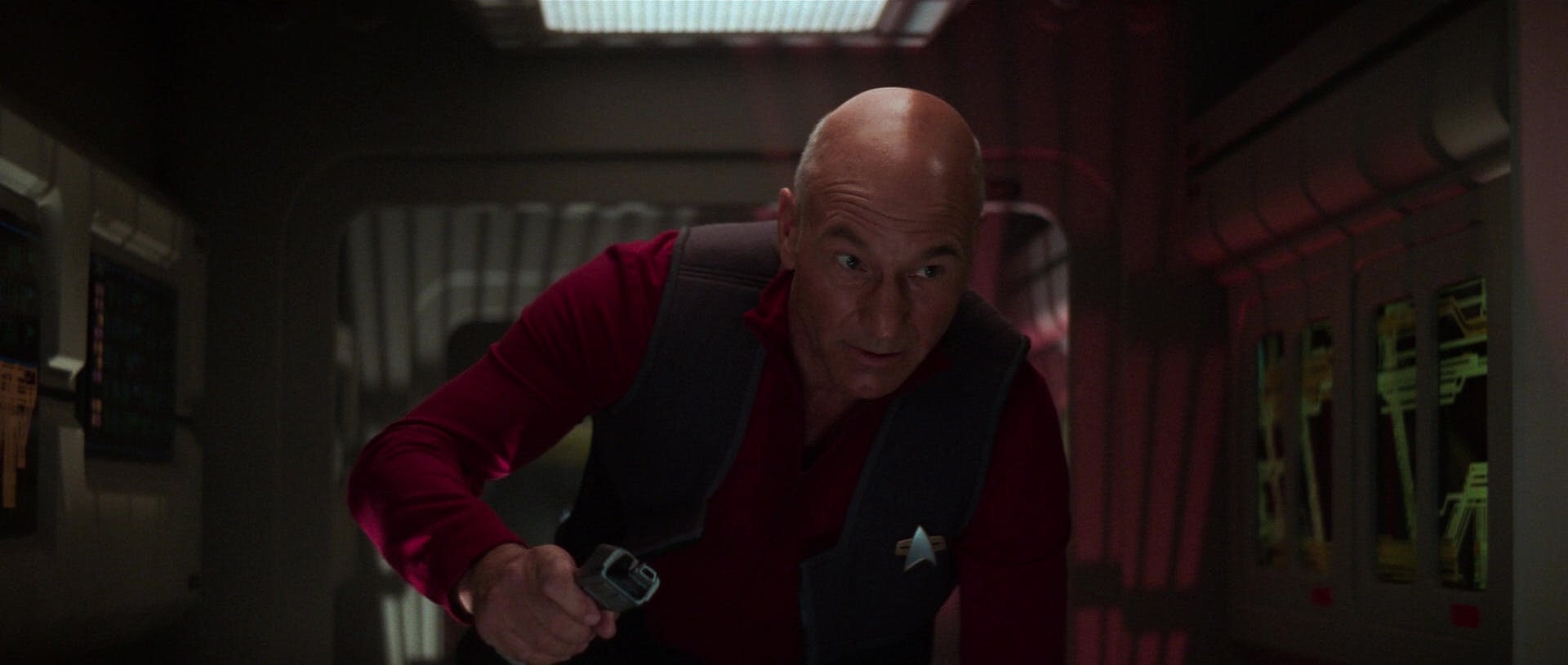 Jean-Luc Picard navigates a Jefferies tube to avoid the Borg while holding on to his phaser in Star Trek: First Contact