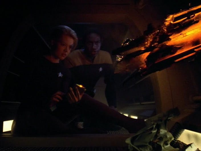 Seven of Nine and Tuvok are crouched in a Jefferies tube as they try to contain an undetonated but still-active torpedo warhead in 'Year of Hell, Part I'